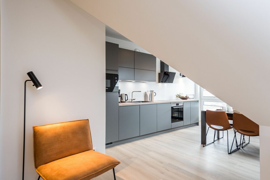 Dachgeschoss Wohnküche in schlichter grauer Optik in Ferienwohnung Grömitz